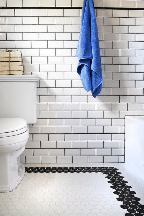 Fabulous bathroom features walls clad in white beveled subway tiles accented with black grout alongside a black pencil border tiles. White Beveled Subway Tile, Beveled Subway Tile, Tile Remodel, Classic Bathroom, Basement Bathroom, Upstairs Bathrooms, Trendy Bathroom, Bathroom Redo, Bath Room