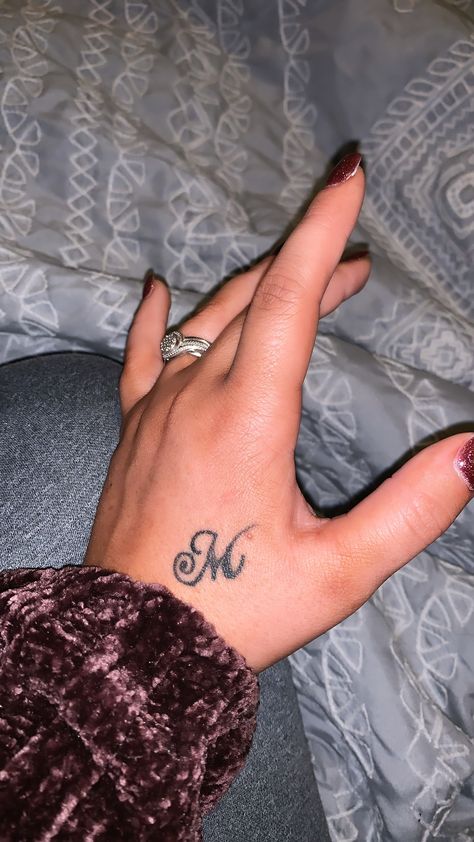 letter “M” hand tattoo #cute #handtattoo M And K Tattoo Letter, Letter Hand Tattoos For Women, Hand Tattoos Initials, Letter M Finger Tattoo, Letter M Tattoo Ideas Initials, M Hand Tattoo, Letter On Hand Tattoo, Hand Tattoos Names, Tatoos Woman Hand Name