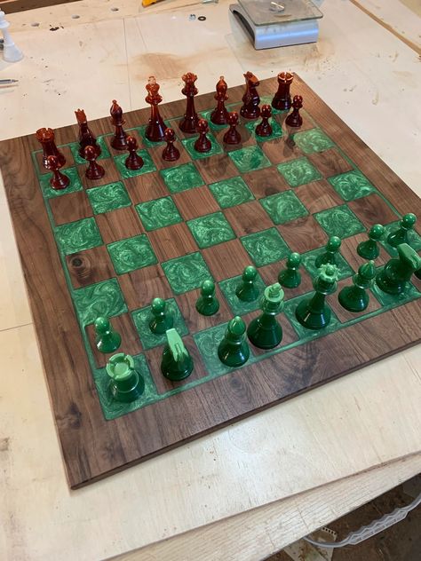 Cut from dark walnut, inlaid with pigmented epoxy resin. Pieces are 3d printed using a resin printer. Project by damantea on Reddit Epoxy Resin Board Games, Epoxy Resin Chessboard, Wood And Epoxy Chess Board, Wood And Resin Chess Board, Epoxy Resin Chess Board, Resin Printer Projects, 3d Resin Printer Projects, Wood And Resin Projects, Epoxy Chess Board