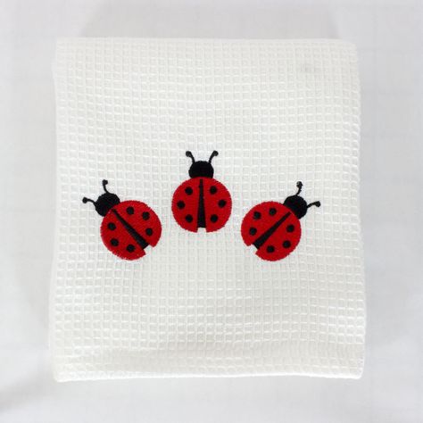 Decorate your Kitchen with this delightful Ladybug Kitchen Tea Towel. The towel is approximately 18 inches by 28 inches, made of 100% cotton with a waffle weave texture embroidered with three red and black Ladybugs. Embroidered in the USA!  The Ladybug Embroidered Kitchen Tea Towel can be personalized with custom embroidery underneath the Ladybugs. Machine Embroidered Clothes, Ladybug Embroidery, Hand Embroidery Ladybug, Ladybug Embroidery Pattern, Ladybug Clothes, Ladybird Embroidery, Embroidered Ladybug, Ladybird Cross Stitch, Ladybug Pattern Design