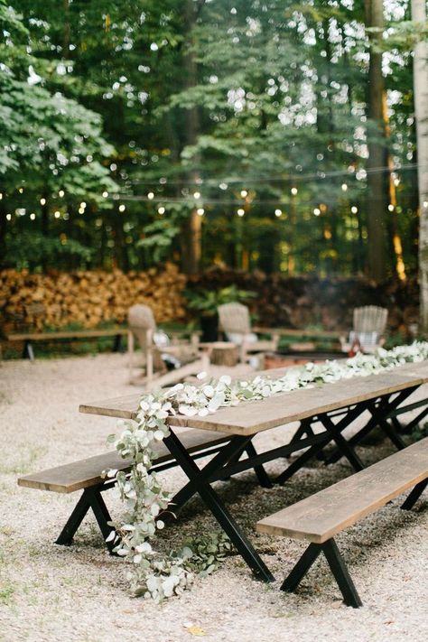 Picnic tables draped with floral garlands and twinkle lights are perfect for an outdoor wedding reception.  #love #inspiration #diy #wedding #decorgoals #ideas Picnic Table Wedding, Outdoor Lights Ideas, Diy Outdoor Lights, Diy Outdoor Weddings, Wooden Benches, Wedding Decorations Ideas, I Do Bbq, Dog House Diy, Outdoor Trees