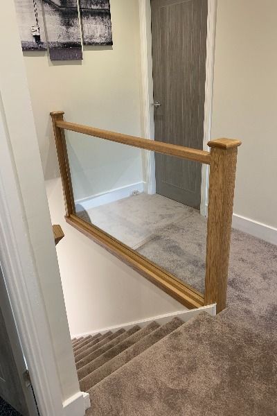 Upstairs Banister, Stairs And Landing Decor, Glass Landing, Glass Bannister, Hallway Coat Storage, Transformation Design, Landing Stairs, Stair Paneling, Glass Handrail