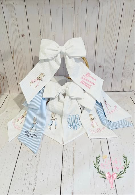 "Custom monogrammed basket bow. Each bow is pre-tied so you don't have to worry about tying a pretty bow, I've done it for you!😊. They are 13 1/2 long, 9 1/2\" wide, and custom made in your choice of fabric, thread, single initial, monogram, or full name and choice of font. You can also add Peter Rabbit in pink, blue or any color of your choice. Each bow is lovingly sewn by me, and I do the embroidery work before I sew the bow, for a clean professional look that doesn't show stitches on the bac Monogrammed Hair Bows, Embroidery Machine Projects, Wreath Sashes, Embroidered Easter Basket, Monogrammed Easter Basket, Bunny Monogram, Custom Easter Baskets, Monogram Bow, Easter Basket Items