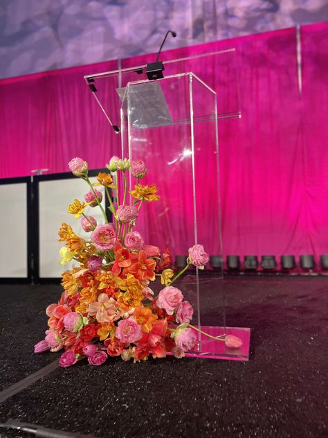 Dress up an acrylic podium with bright florals to captivate your guests✨🌷 #bfloralnyc #acrylic #bright #flowers #gala Podium Decorations Events, Acrylic Stage Design, Ceremony Podium Flowers, Acrylic Flower Stand, Podium Floral Arrangements, Podium Flower Arrangements, Stage Flower Arrangements, Acrylic Podium, Podium Flowers