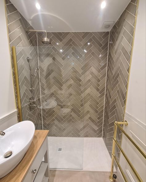 Grey subway tile, herringbone pattern, walk in shower with small grated drain Shower Herringbone Tile, Small Herringbone Shower Tile, Bathroom Shower Tile Ideas Walk In Herringbone Pattern, Walk In Shower Herringbone Tile, Shower Remodel Herringbone, Chevron Bathroom Tile, Dark Grey Herringbone Tile Bathroom, Grey Herringbone Shower Floor, Herringbone Bathroom