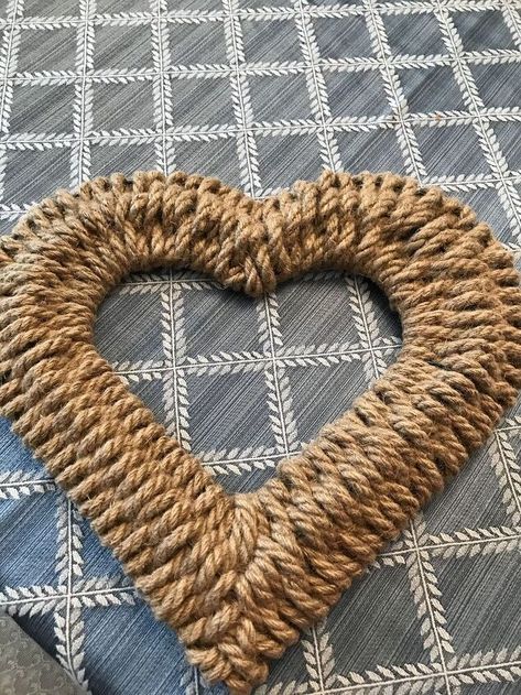 I began by buying the heart shaped wreath form from Dollar Tree. Next I bought several pieces of the nautical jute rope. FYI, originally they were sold at Dollar Tree with 13.5 feet and now they are being sold for 9.5 feet. Less rope for same money. 🤯 But I digress. I began by holding a straight piece of rope about 4 inches long. Then I began weaving the rope from the outside rim over then under the next wire, then over the next, then under the next wire. On the next row back over, the… Wire Heart Wreath Form Ideas, Rope Heart Wreath Diy, Dollar Tree Heart Wreath Diy, Heart Wreath Ideas, Dollar Tree Infinity Love Wreath Ideas, Wicker Heart Wreath Ideas, Valentine Wire Wreath Ideas, Jute Wreath, Heart Wire Frame Wreath