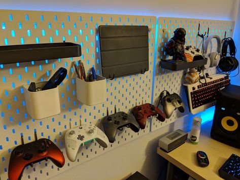 Gaming Room Pegboard, Remote Wall Holder, Ikea Pegboard Boys Room, Gamer Room Organization, Pegboard Game Room, Peg Board In Bedroom, Ikea Pegboard Gaming Setup, Ikea Wall Pegboard, Ikea Gamer Room