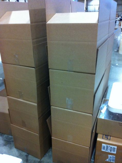 While we reuse and recycle our cardboard boxes, some clients prefer to use new boxes, or their own branded cartons for shipping.  We're happy to oblige!  Here's a stack of new boxes just waiting for some shirts.  www.visualimp.com Big Cardboard Boxes, Camp Jupiter, Reuse And Recycle, Business Baby, Courier Service, Cardboard Box, Work Hard, Basement, Quick Saves