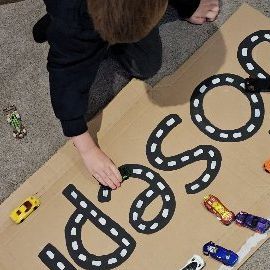 Katie-Rose Hardie on Instagram: "𝗡𝗮𝗺𝗲 𝗧𝗿𝗮𝗰𝗸 Joseph is getting really good at writing his name, but he always manages to do his 's' back to front. So I made him his name in car track form and he can practice driving over all the letters over and over again! I love finding ways to reuse cardboard packaging! #recycled_play #diyplayideas #diyplaythings #cardboardcrafts #letterformation #hotwheels #phonics #eyfsliteracyideas #eyfsteacher #eyfsteachersofinstagram #playathome #funbudgetplay #november_play" Katie Rose, December Christmas, Daycare Ideas, Letter Formation, Cardboard Packaging, Toddler Learning Activities, Cardboard Crafts, In Car, Toddler Learning