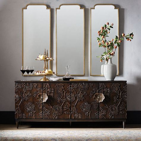 A true work of art for your dining room, living room or entryway. Handcarved, Jacobean-inspired floral detailing adorns the front and sides. Hewn of solid wood with cast-bronze handles, adjustable shelves and a concealed hole to feed cords through.Acacia wood with nutmeg finish. Cast-bronze floral handles. Adjustable shelves. Soft-close hinges. Levelers. Cord management and wire access hole. Shelves hold up to 50 lbs.. Because these items are individually handcarved, availability may be temporar Dining Room Buffet, Expandable Dining Table, Furniture Placement, Empty Nest, Shop Storage, Building A New Home, Sideboard Cabinet, Bar Cabinet, Wood Dining Table