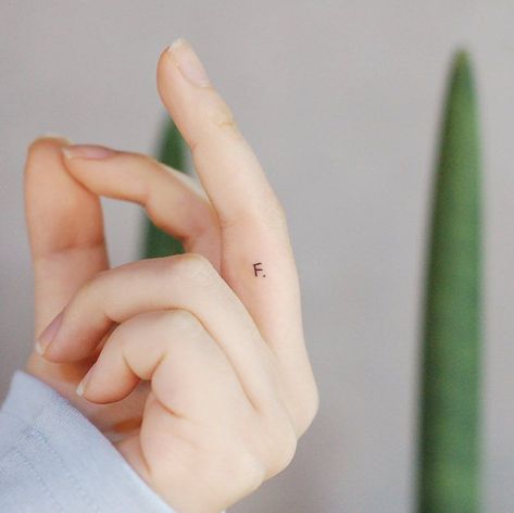 24 Pretty Finger Tattoo Ideas For Women Initial Tattoo Placement, Fingers Tattoos, Tattoos Letters, Letter J Tattoo, Inside Finger Tattoos, Small Letter Tattoo, Initial Tattoos, Flower Finger Tattoos, F Tattoo