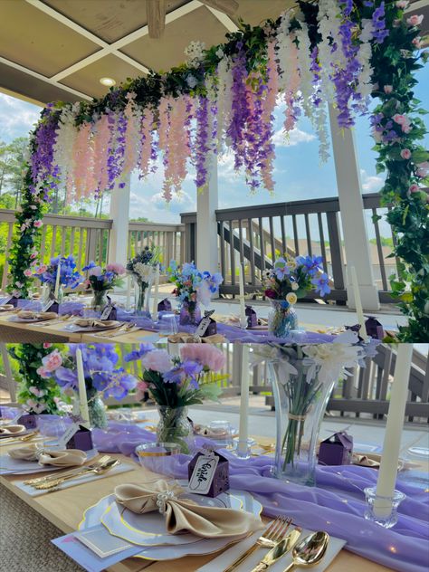 Floor table summer setup with pink, white, and purple wisteria looming over in a pipeline setup, twined with floral and eucalyptus garlands Purple Tea Party, Teacup Party, Fairy Picnic, Pink Graduation Party, 35 Birthday, Bridgerton Party, Diy Tea Party, Graduation Party Table, Wedding Pool Party