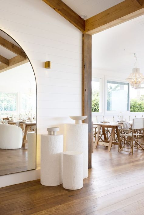 Renovated farmhouse with timber beams and flooring. White VJ walls and styled plinths. Large Arch Mirror, Tree Restaurant, Globe West, Farmhouse Interior Design, Timber Beams, Hardwood Furniture, Arch Mirror, Mirror Interior, Farmhouse Interior