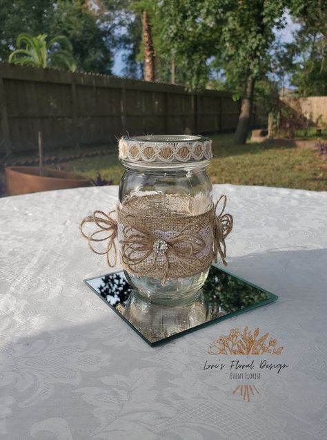 Rustic & Glam Mason Jar Centerpiece | Weddings | Bridal Shower | Baby Shower | Centerpieces | Burlap | Lace | Embellishment Perfect for Weddings, Bridal Showers, Baby Showers & Much More This design is all the way around! Each Jar is Made to order  16 oz. jars Rhinestone & Twine Lace Burlap If you have any questions feel free to message me.  If you are needing your items earlier please message me. *Mirror is for pictures/display Mirror is not included *Each item is handmade and design may vary. Decorated Mason Jars Wedding, Rustic Wedding Centerpieces Mason Jars Eucalyptus, Mason Jar Lace Centerpieces, Wedding Centerpieces Rustic Mason Jars Wood Slices, Jar Centerpiece Wedding, Burlap And Lace Mason Jar Centerpieces, Jar Centerpieces, Jar Decor, Rustic Glam