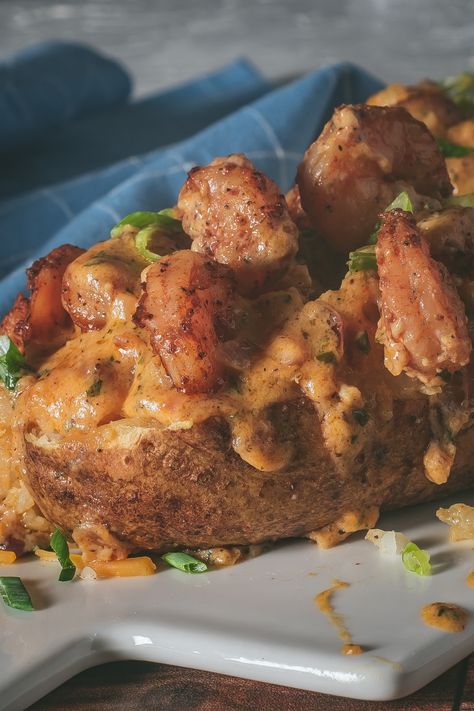 These loaded shrimp baked potatoes are a seafood lover's dream, combining the rich flavors of perfectly baked potatoes with a decadent creamy Cajun shrimp Seafood Baked Potato, Seafood Thanksgiving, Creamy Cajun Shrimp Sauce, Cajun Shrimp Sauce, Crab Beignets, Creamy Cajun Shrimp, Cajun Sauce, Stuffed Baked Potatoes, Seafood Bake