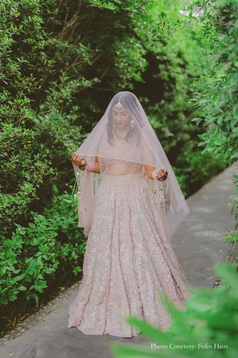 Indian wedding, wedding day, beautiful Indian bride, Indian bridal wear, traditional Indian wedding dress, Indian bride outfit, bridal fashion, elegant bridal attire, pale pink lehenga, bridal veil, wedding photography, wedding portraits, bridal look Indian, wedding themes, wedding celebrations, bride entry, stunning bridal entry, bridal pink lehenga, indian bride entry, indian bride with veil Indian Bride With Veil, Lehenga With Veil, Indian Bride Entry, Bridal Pink Lehenga, Pink Lehenga Bridal, Traditional Indian Wedding Dress, Bridal Look Indian, Engagement Indian, Bride With Veil