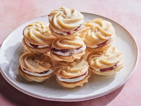 With their beautiful, swirled tops and vibrant filling, these Viennese whirls are sure to look divine on any holiday cookie platter. Despite their name, the delicate, buttery shortbread cookies are a favorite sweet treat in England. They’re sandwiched with a homemade vanilla bean buttercream and a spoonful of raspberry jam, which is traditional, but feel free to substitute with your favorite jam. Viennese Whirls, Vanilla Bean Buttercream, Best Christmas Cookie Recipe, Buttery Shortbread Cookies, Christmas Cookie Recipes, British Baking, Best Christmas Cookies, How To Make Sandwich, Homemade Vanilla