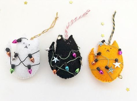 If you are looking for a quirky and unique decoration or a sweet stocking filler for this Christmas search no more! This cute cat in the Christmas lights felt decoration is hand stitched and ready to bring a big smile on your face! Perfect for a cat lover gift! Choose your cat colour; available in white, black, grey and orange! These decorations are made to order; each of them is slightly different as handmade therefore unique! Quirky Christmas, Felt Crafts Christmas, Cat Christmas Ornaments, Felt Crafts Diy, Christmas Cute, Decoration Originale, Craft Show Ideas, Felt Decorations, Felt Christmas Ornaments