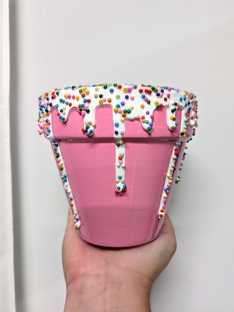 Birthday Cake - This 4 inch pot sure is a sweetie! This adorable planter would look so cute paired with a favorite succulent plant. This plant pot is perfect for a birthday gift or decor for a birthday party. Painted in creamy pink acrylic and dripping with white acrylic frosting. Topped with faux rainbow sprinkles to add a touch of sweetness!   This terracotta pot was treated with a water sealant prior to painting and does have a drainage hole. The interior is sealed with a gloss varnish. The e Cute Planters Pots Diy, Garden Pot Painting, Cute Plant Pots Painting, Succulent Pot Ideas Diy, Pots Design Ideas, Pottery Paint Ideas, Pot Decorating Ideas, Painting Pots Ideas, Terracotta Pot Painting Ideas