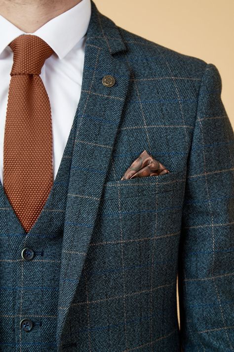 Show up in style with the blue Scott three piece suit. This vintage inspired suit draws inspiration from old age country tweeds, featuring a subtle check laid upon a durable heavyweight fabric, making it ideal for imitating that suave Peaky Blinders style. Character is added with the navy velvet contrast pocket trims and an eye-catching orange paisley pocket square peeking through the top pocket. Model wears size 40R blazer, 40R waistcoat & 34R trousers. Features Slim fit Single-breasted Notch l Wedding Suits Groom Navy Blue, Non Traditional Suits For Men, Double Breasted Tweed Suit, Irish Wedding Suit, Autumn Suit Men Wedding, Mens Wedding Suits Summer, British Suits Men Wedding, Art Deco Wedding Mens Suits, Unique Mens Suits Wedding