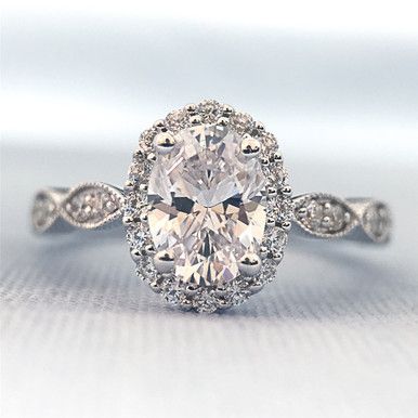 The perfect oval halo ring that you ever did see! Romance created a beautiful engagement ring that is going to be a fast favorite. Made of 18k white gold, this ring fits a 7x5mm oval diamond and has 1/3ctw of diamonds. A scalloped milgrain shank gives this ring a dainty and pretty look. Need a size not listed? Contact us today! Oval Halo Moissanite Engagement Ring, Oval Antique Engagement Rings, Unique Oval Engagement Ring Vintage, Beautiful Rings Engagement, Unique Halo Engagement Rings, Beautiful Engagement Rings Unique, Oval Engagement Ring With Halo, Engagement Rings With Halo, Italian Engagement Ring