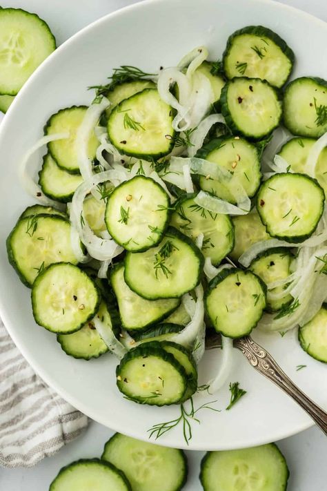 Overhead shot of cucumber and onion salad garnished with dill, arranged in a white plate. Next to it there are more cucumber slices and sprigs of dill Cucumber Dishes, Cucumber And Onion Salad, How To Store Cucumbers, Cucumber And Onion, Cucumber Onion Salad, Jerk Shrimp, Fresh Herb Recipes, Cucumber Onion, Southern Potato Salad