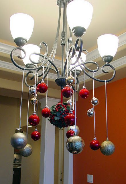 Ornaments hanging from the chandelier. Chandelier Decorations For Christmas, Decorate Chandelier For Christmas, Christmas Chandelier Ideas, Christmas Chandelier Decor, Chandelier Decorations, Christmas Chandelier, Diy Christmas Lights, Festive Holiday Decor, Easy Christmas Decorations