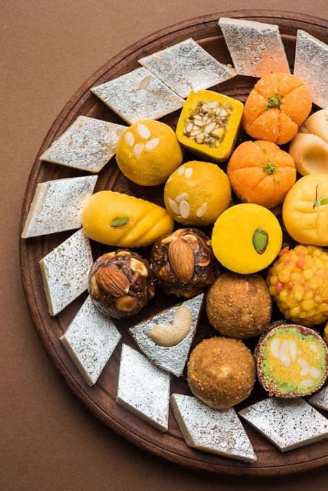 various Indian Sweets on a large brown platter Indian Food Menu, Tandoori Fish, Sweets Photography, Indian Food Photography, Indian Cheese, Diwali Sweets, Diwali Food, Indian Dessert Recipes, India Food