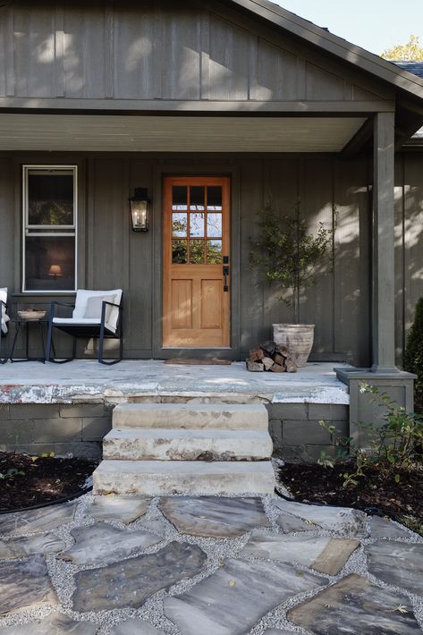 Foxglove flagstone path to our front porch. How to lay a flagstone walkway. Blue, orange, and tan flagstone path inspiration. Organic and whimsical path to house. Hunter green board and batten house exterior. Exterior design inspiration. Muddled Basil by Sherwin Williams paint color. Landscaping and hardscape design exteriors. Flagstone path tutorial by Nadine Stay | #flagstonepath #flagstonewalkway #diy #exteriordesign Front Porch Board And Batten, Dark House Front Porch, Sherwin Williams Muddled Basil, Board And Batten Cottage Exterior, Flagstone House Exterior, Muddled Basil Exterior, Mud Room Addition Exterior, Green Ranch House, Modern Cotswold House