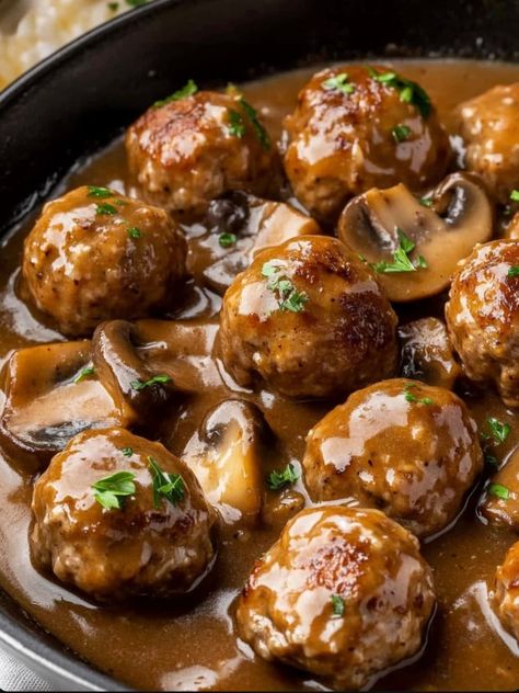 Slow Cooker Salisbury Steak Meatballs are a comforting and savory meal that combines juicy meatballs with a rich, flavorful mushroom gravy. These meatballs are perfect for an easy weeknight dinner or a weekend meal with … Salsbury Steak Frozen Meatball, Salisbury Steak Meatballs And Mushroom Gravy, Keto Meatballs And Gravy, Salisbury Steak Meatballs With Mushroom Gravy, Mushroom Gravy Meatballs, Meatballs Mushroom Gravy, Meatball Mushroom Recipes, Meatballs In Gravy Crockpot, Turkey Salisbury Steak Recipes