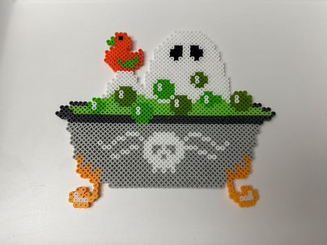 Ghost taking a bath in a green potion:) This ghost bathing in a spooky bath makes for the perfect decoration or gift just in time for Halloween! It looks great on walls and fridges! This ghost fella was hand crafted and ironed on both sides to ensure sturdiness. These beads are sturdy but will break if roughly handled! Each item is made to order, so items may appear different than pictured. Please don't hesitate to reach out if there are any questions  Thank you so much for your time and feel fr Perler Bead Patterns Spooky, Iron Beads Halloween, Best Perler Bead Patterns, Perler Bead Inspiration, Iron Bead Art Ideas, Halloween Fuse Beads, Spooky Perler Bead Patterns, Adult Perler Bead Patterns, Perler Bead Ghost