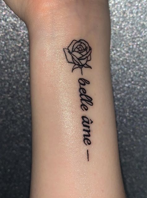 Tattoos, rose, quote, rose tattoo, quote tattoo, french tattoo, girly tattoo Beautiful In French Tattoo, Rose Word Tattoo, Rose Quote Tattoo, Flower Word Tattoo, Flower With Words Tattoo, Wrist Rose Tattoo, Belle Ame Tattoo, Stomach Tats, Rose Tattoo On Side