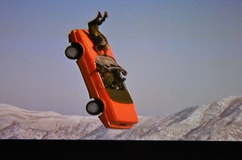 And in Terminal Velocity, skydiving instructor Charlie Sheen drives a Cadillac Allante convertible out of a flying cargo plane in mid-air. He freefalls and lands between the windmills while being pursued by villain James Gandolfini, whose parachute tangles in the spinning blades. Terminal Velocity, Bad Movies, Cargo Plane, James Gandolfini, Charlie Sheen, Worst Movies, Sweet Cars, Skydiving, Weird And Wonderful