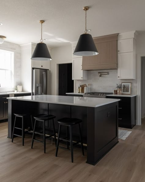 Caliber Homes | Custom Homebuilder | Loving this classic black and ivory kitchen for a recent custom client. 🖤🤍 Peep that brass foot rail on the island!… | Instagram Black Panel Kitchen Island, White Oak Island Black Countertop, Black Island Wood Countertop, Kitchen Island Iron Ore, Iron Ore Kitchen Island, White Island Countertop Black Perimeter, Brass Foot Rail, Ivory Kitchen, Kitchen Hood Design