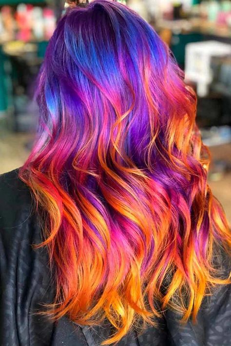 Sunset Ombre Long Hairstyle #multicoloredhair ★ Purple ombre hair is literally everywhere for its endless variety of shades. You can mix it with blue and pink, rock lavender balayage, and flaunt with anything from dark to light pastel. Dive in to find the best color for brunettes and blondes! #glaminati #hairstyles #purpleombrehair #Longhaircolor Purple And Blonde Ombre Hair, Sunset Hair Color Peek A Boo, Sunset Colored Hair, Ombre Hair Ideas For Brunettes, Purple Sunset Hair, Fun Hair Color Ideas For Brunettes Ombre, Long Colorful Hair, Sunset Peekaboo Hair, Wild Hair Color Ideas