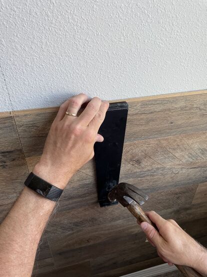 If you want to make a huge impact in a room, consider adding a wood feature wall. It's a great way to add texture and warmth to a room. Our son wanted a cozy bedroom with some type of wood paneling, and installing a wood feature wall helped turn it into a rustic retreat! It really made the room look fabulous! If you want to see what happened, keep reading and take our advice for installing flooring on your wall!! Gather Gather or purchase the following supplies needed for this pr… Lvp Flooring On Walls, Using Flooring On Walls, Wood Flooring On Walls, Floor Planks On Walls, Flooring On Walls Ideas, Laminate Wall Ideas, What To Do With Left Over Vinyl Plank Flooring, Wood Planking On Walls, Wood Floor On Wall