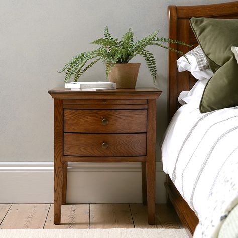 A modern yet classic design, our Winchcombe bedside features an elegant bow front and two spacious drawers. A slim pull-out tray offers a handy perch for a morning coffee. Winchcombe Dark Oak Inspired by a chance encounter with a charming piece of French antique furniture, Winchcombe Oak is a timeless and thoughtfully designed range with a rich and distinctive finish. Warm and characterful with a beautiful natural grain running through it, it's all about the finer details with Winchcombe. From s Dark Oak Furniture, Cotswold Company, Beautiful Bedside Tables, Oak Nightstand, Oak Bedside Tables, Drawer Bedside Table, Super King Size Bed, Dining Furniture Sets, Hallway Furniture