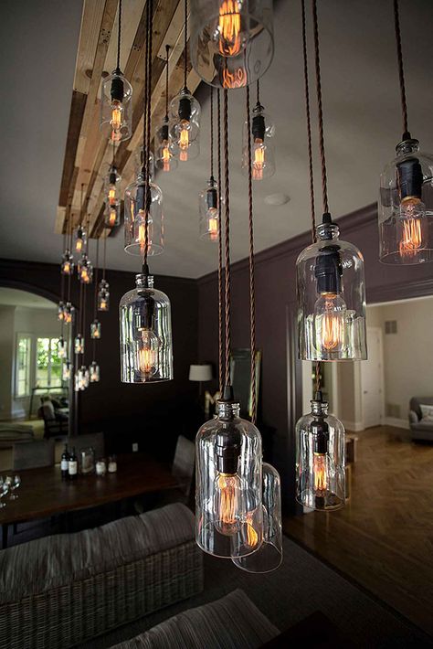 Our New Yorker chandelier features 32 clear growler bottles on an oak canopy stained in alternating tones. This particular one hangs in a client’s home in Sands Point, Long Island and is 11 feet long! Living Room Lighting Ceiling Chandeliers, Modern Rustic Chandelier, Bottle Chandelier, Rustic Light Fixtures, Custom Chandelier, Modern Rustic Decor, Recycled Bottle, Ceiling Lights Living Room, Rustic Chandelier