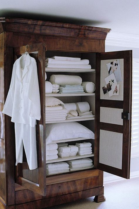 dark-brown-wood-armoire-remodelista Muebles Shabby Chic, White Linens, Wood Armoire, Linen Cupboard, 아파트 인테리어, Massage Room, Bed In Closet, Linen Storage, Tiny Bedroom