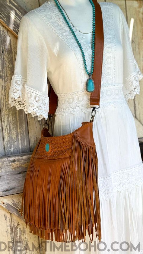 Embrace effortless bohemian style with our Triple Fringe Leather Crossbody Bag, a standout accessory for free spirits. Handcrafted from high-quality genuine leather, this stunning bag features triple-layered fringe that flows beautifully with every step. The intricate weaved detailing on the top panel adds a touch of artisanal craftsmanship, while the vibrant turquoise gemstone centrepiece brings an earthy, vibrant charm. Designed for versatility and comfort, the crossbody strap ensures all-day wearability, making it perfect for festivals, markets, or everyday adventures. Available in three unique colours, this boho bag is your ultimate go to for adding texture and individuality to any outfit. Bring bold, bohemian elegance into your everyday life with this one-of-a-kind leather crossbody b Bold Bohemian, Layered Fringe, Unique Colours, Everyday Adventures, Boho Bag, Turquoise Gemstone, Free Spirit, Unique Colors, Crossbody Strap