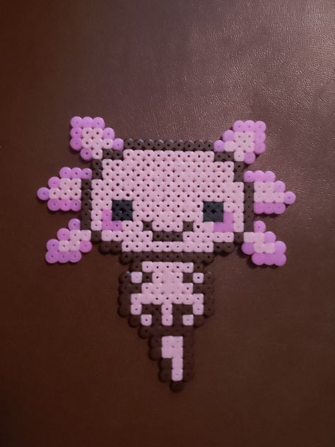 An axolotl Axolotl Melty Beads, Axolotl Pearl Beads, Axolotl Fuse Beads, Perler Axolotl, Axolotl Bead Pattern, Axolotl Perler Bead Patterns, Beaded Axolotl, Axolotl Perler Beads, Axolotl Crafts