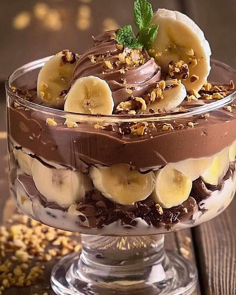 Our Chocolate Peanut Butter Banana Cream Trifle is a crowd-pleaser that's as fun to make as it is to eat. Imagine layers of rich chocolate cake, creamy peanut butter filling, and fresh bananas, all topped with whipped cream and chocolate shavings. This trifle is perfect for parties, family gatherings, or just treating yourself. Let’s dive into this layered paradise! Resume of the Recipe: This Chocolate Peanut Butter Banana Cream Trifle is a delicious and easy-to-assemble dessert. With layers ... Banana Cream Trifle, Chip Butty, Rich Chocolate Cake, Dark Chocolate Cakes, Peanut Butter Filling, Chocolate Cake Mixes, British Food, Banana Cream, Chocolate Shavings