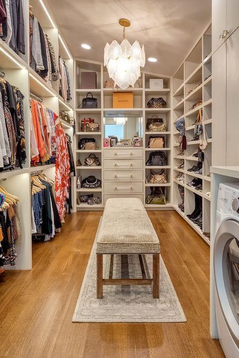 A gray bench sits on a gray runner beneath a glass leaf chandelier and between stacked clothing rails and white built-in shoe shelves. Closet Bench, Master Closet Design, House Closet, Built In Dresser, Dressing Room Closet, Walking Closet, Dream Closet Design, Closet Design Layout, Walk In Closet Design