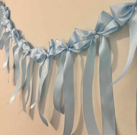 Add a charming touch to your event with my handmade Satin Bow Garland-- available in lengths of 3 or 6 feet and a variety of colors, making it perfect for any celebration. This bow garland adds a delicate, dainty touch to nurseries, bridal showers, baby showers, weddings, bow birthdays, and more. Key Features: * Lengths: 3 feet or 6 feet * Lightweight & Easy to Hang: Each garland is designed with twine loops at the ends for easy hanging. Create a stunning backdrop or add a subtle accent to your Blue Bow Bridal Shower Theme, Blue Bow Baby Shower Theme, Ribbon Decor, Coquette Ribbon, Bow Garland, Decor For Nursery, Grad Parties, Satin Bow, Blue Satin