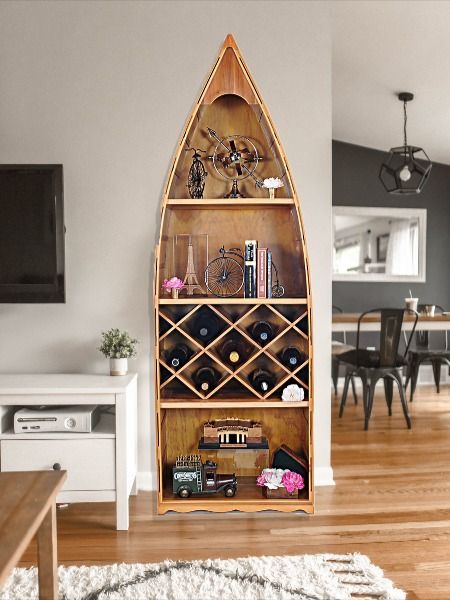 Take the indoors home with you with this elegant wooden canoe wine shelf! 

Hand-joined strips of cedar make this special shelf a masterpiece of hand craftsmanship. 

The ideal gift for boat lovers and wine connoisseurs alike.  

L: 74 W: 24.5 H: 12.5 Inches Boat Shelf Decor, Canoe Shelves, Canoe Shelf, Boat Bookcase, Boat Shelf, Blue And White Living Room, Wine Shelf, Wooden Canoe, Wine Shelves