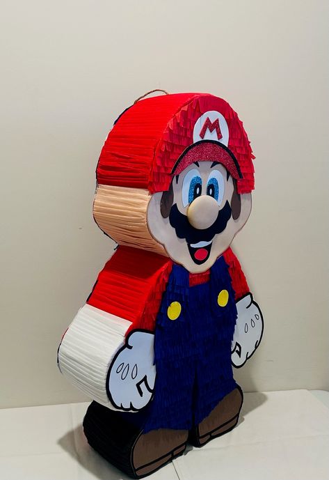 Mario Piñata perfect for any Nintendo themed party or event! -No staples used. Tape and silicon used to form cardboard base. Copyright Disclaimer: Please be Advised that we do not own copyrights or trademarks of any characters. All registered trademarks and copyrights of character belong to their respective owners and are not being sold. Any likenesses, descriptions. or copies of character used are one time request from, customers for our labor, materials, and services. Christmas Pinatas, Christmas Piñatas, Piñata Ideas, Super Mario Birthday Party, Mario Birthday Party, Super Mario Birthday, Mario Birthday, Mario Bros., Trunk Or Treat