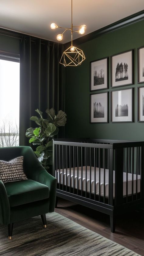 A dark and moody nursery with a deep green wall, a black crib, and a green velvet armchair accented by a patterned pillow. The space features gold geometric lighting, black-and-white framed photos of nature, and a large potted plant for a modern, serene vibe. Black And Neutral Nursery Ideas, Dark Blue Accent Wall Nursery, Baby Girl Nursery Dark Furniture, Dark Green And Pink Nursery, Dark Nursery Ideas Girl, Dark Green Boy Nursery, Dark Forest Nursery, Dark Green Nursery Girl, Moody Kids Room