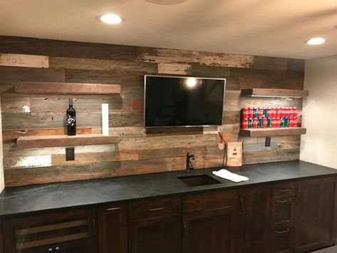 Bar back wall planking with walnut floating shelves turned out quite lovely. Bar Back Wall Ideas, Bar Back Wall Design, Home Bar With Tv, Pallet Backsplash, Basement Remodel Bar, Bar Floating Shelves, Refinish Basement, Bar With Tv, Bar With Floating Shelves