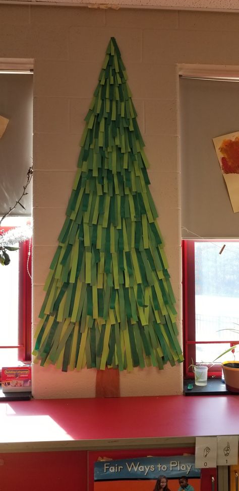 Big Paper Christmas Tree On Wall, Big Paper Christmas Tree, Diy Paper Christmas Tree Wall, Christmas Tree Construction Paper, Christmas Tree Hallway Decorations, Rocking Around The Christmas Tree Door, Christmas Classroom Decorations Wall, Classroom Wall Christmas Tree, Tree For Door Decoration