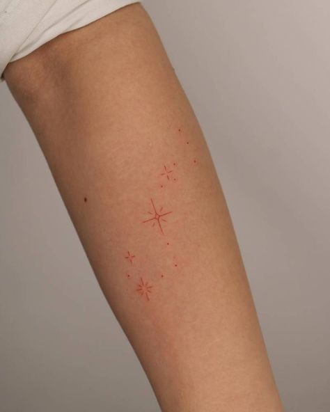 Fine line style cute red stars tattooed on the forearm. Red Stars Tattoo, Star Arm Tattoos For Women, Red Sparkle Tattoo, Red Star Tattoo, Fine Line Forearm Tattoo, Fine Line Star Tattoo, Red Line Tattoo, Eternity Tattoo, Firework Tattoo